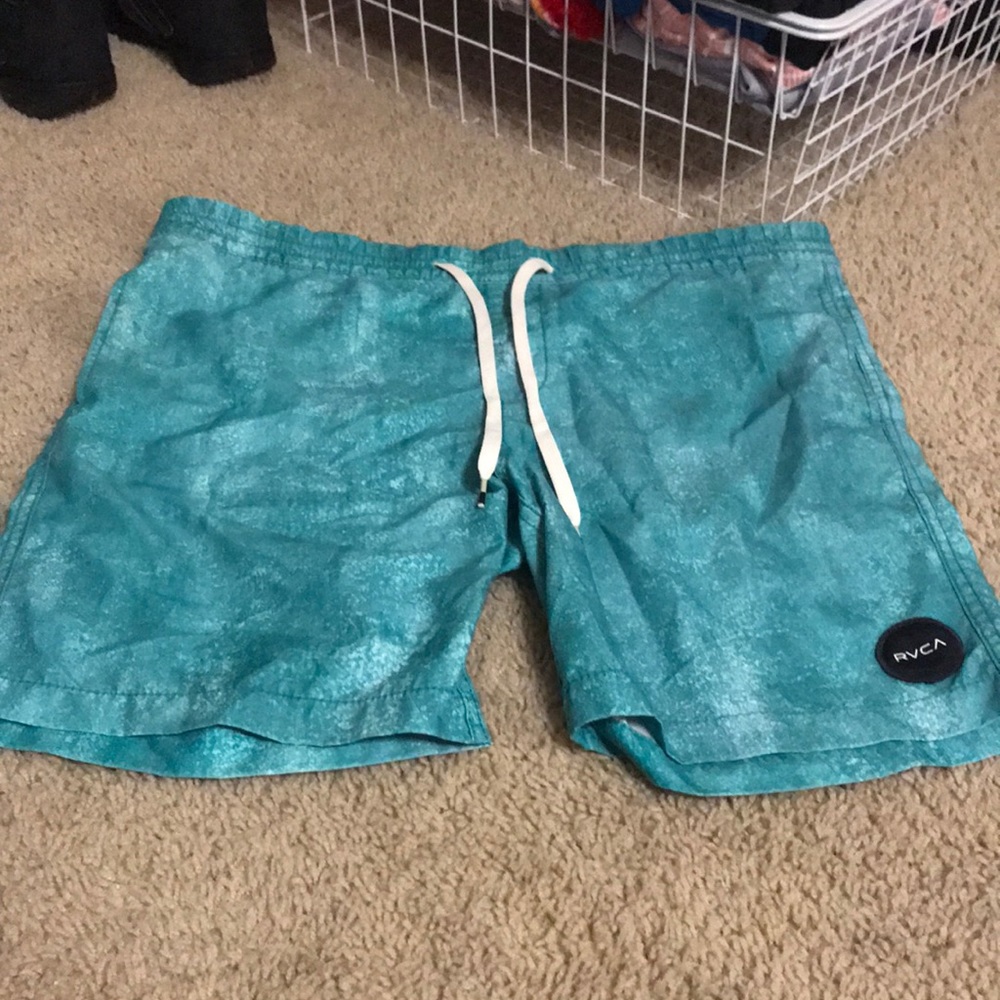 Turquoise RVCA swim trunks.